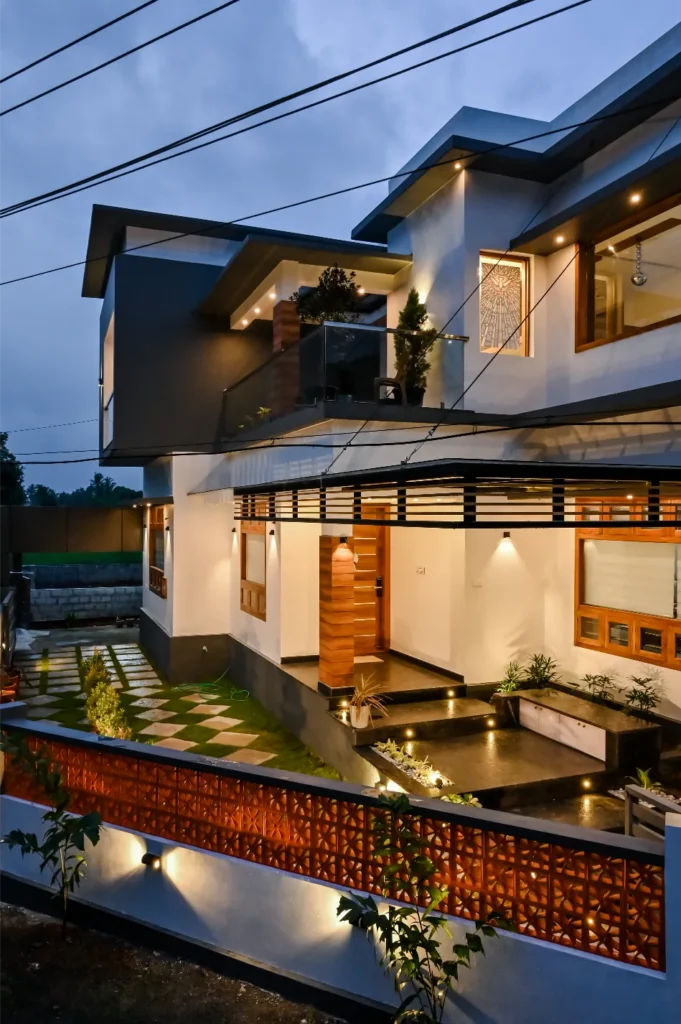 Modern two-storey house exterior at night – Avanti Residence, Patturaikkal, Thrissur by VB Infra