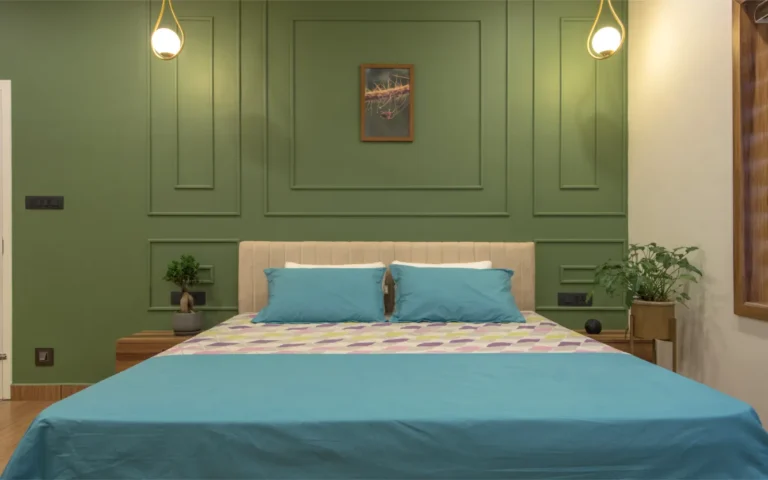 Bedroom interior with green wall panel and pendant lights – Castle Residence Thiroor