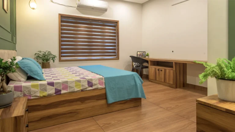 Master bedroom with wooden flooring and large desk – Castle Residence Thiroor