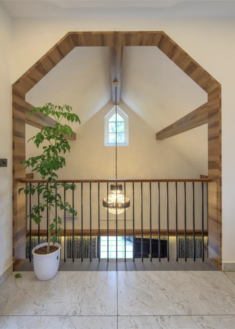 Balcony view of living area with chandelier – Castle Residence Thiroor