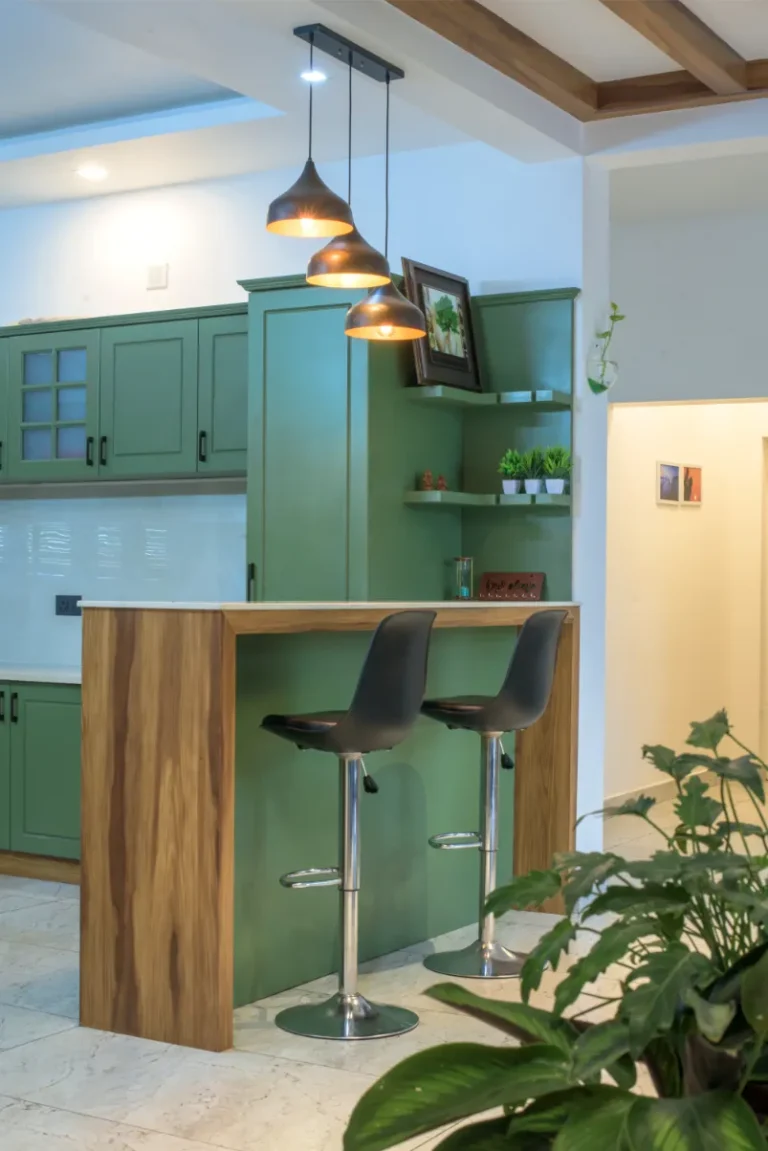 Dining area view with breakfast counter and hanging lights – Castle Residence Thiroor