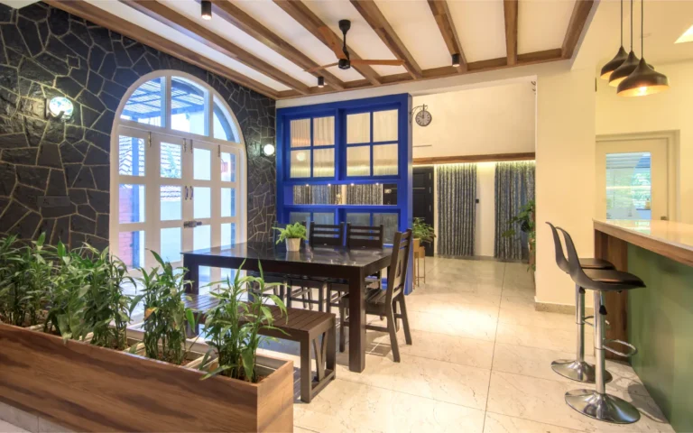 Full view of dining and kitchen with bar stools – Castle Residence Thiroor