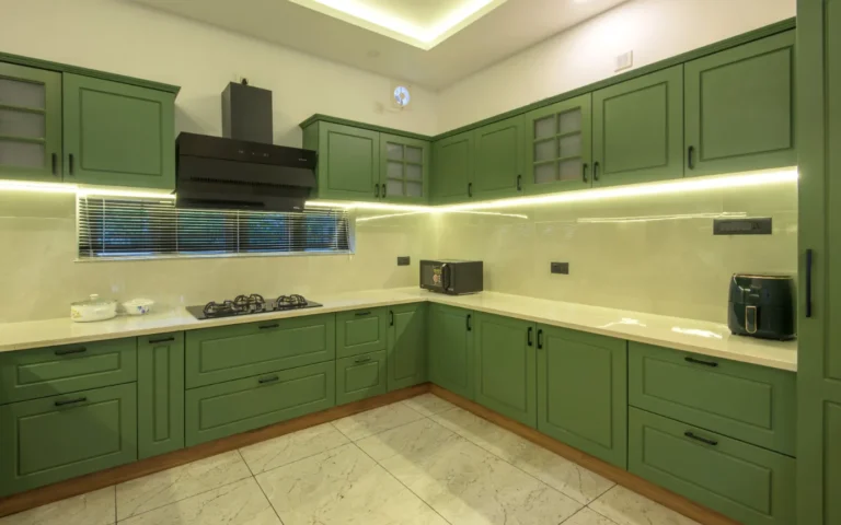 Kitchen with under-cabinet lighting and appliances – Castle Residence Thiroor