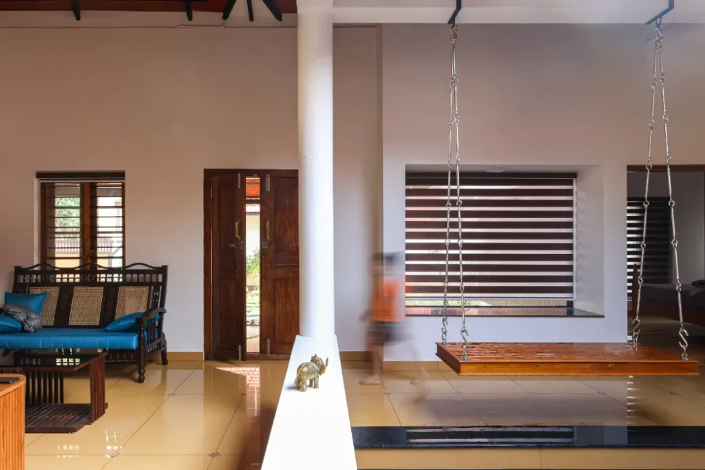 Living room with swing and child motion blur – Courtyard House Wadakkanchery