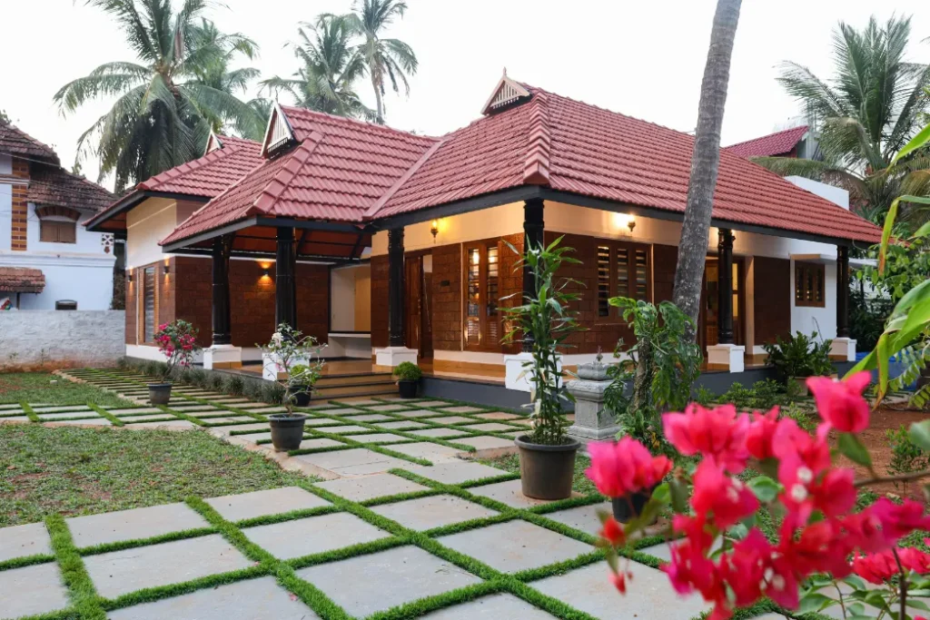 Traditional Kerala-style exterior with red-tiled roof – Courtyard House Wadakkanchery