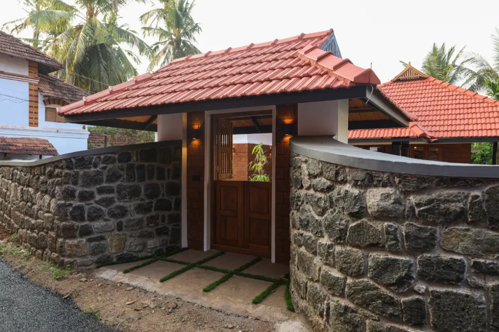 Stone compound wall and tiled gatehouse – Courtyard House Wadakkanchery
