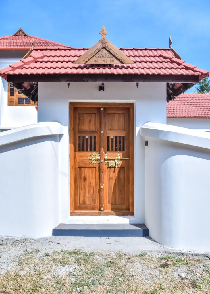 Traditional Kerala wooden gate with brass lock – Trikkur Residence Thrissur