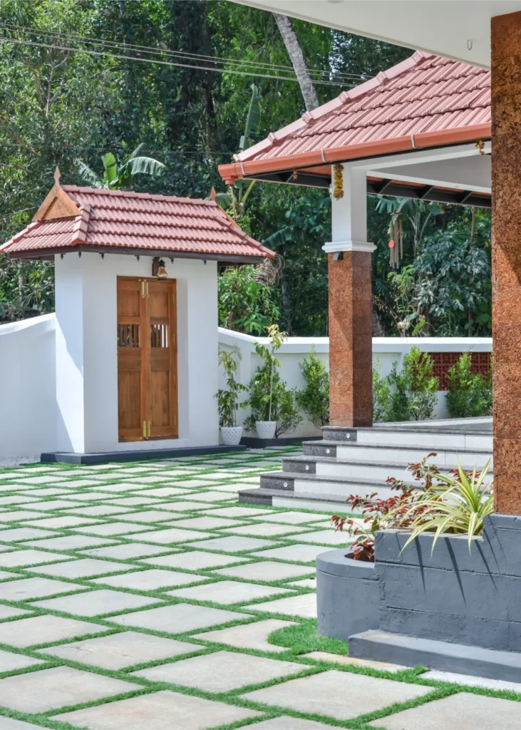 Driveway with patterned grass pavers and tiled entry pavilion – Trikkur Residence Thrissur