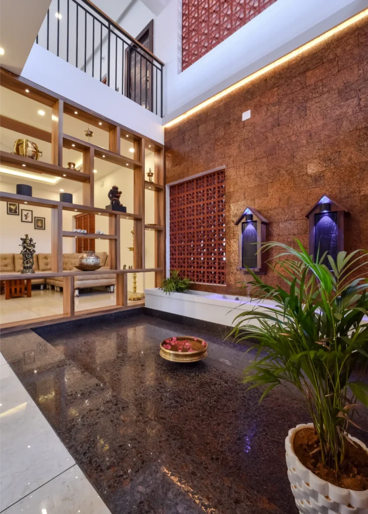 Courtyard with indoor pond and decorative lighting – Trikkur Residence Thrissur