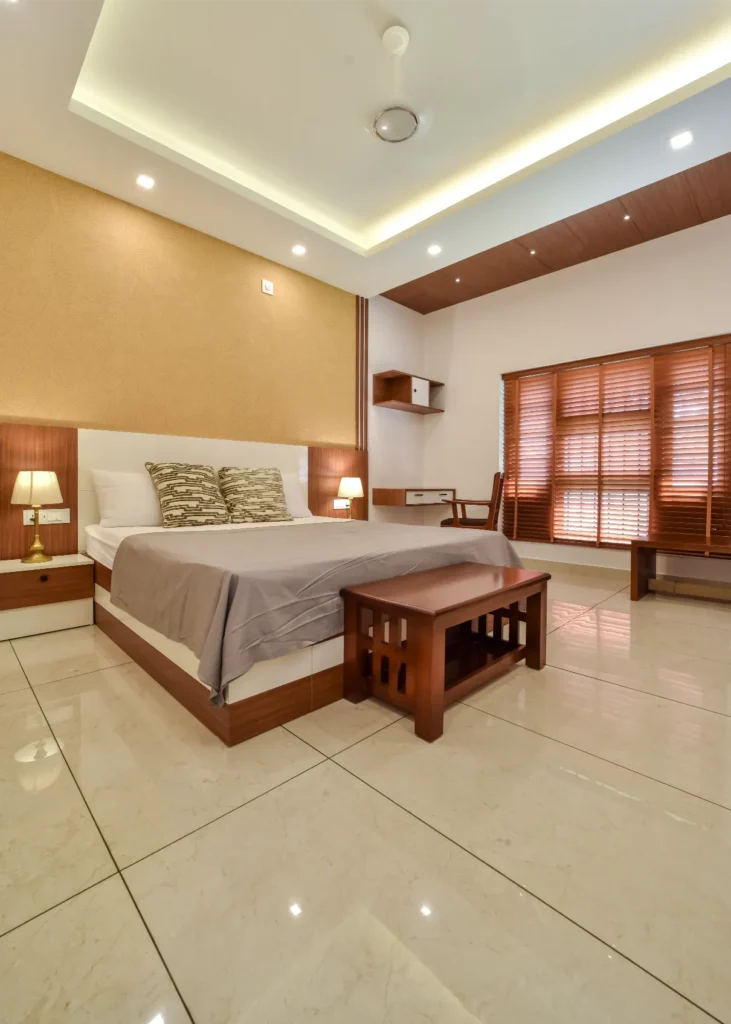 Master bedroom with wooden furniture and ambient lighting – Trikkur Residence Thrissur