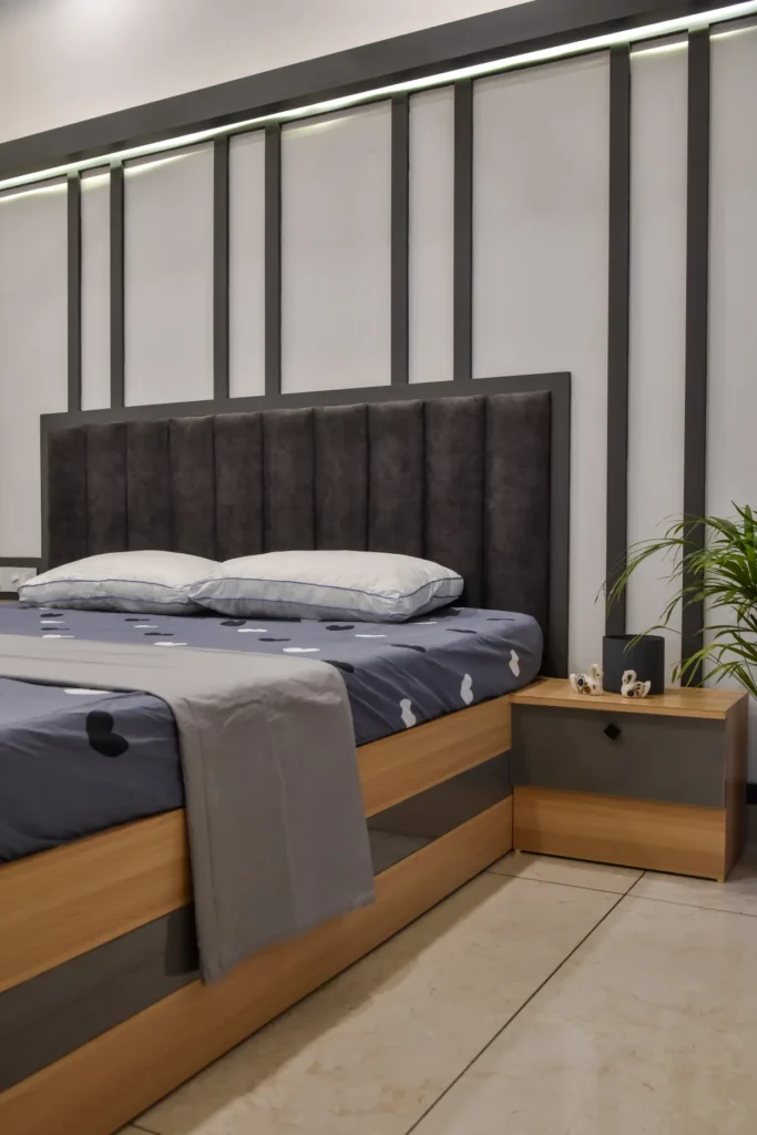 Bedroom with grey padded headboard and modern design – Trikkur Residence Thrissur