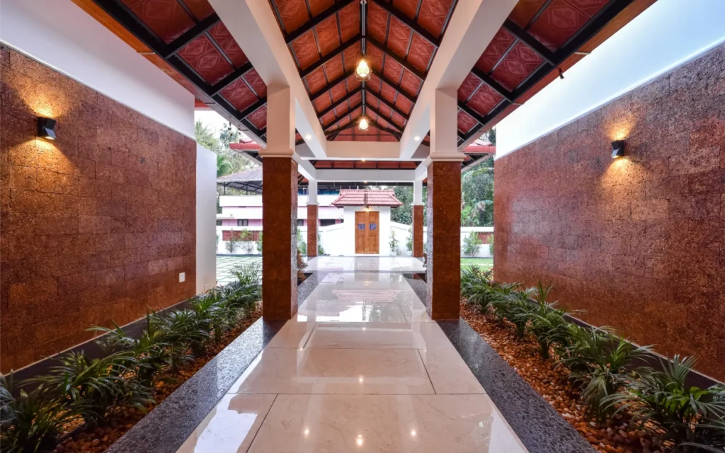 Entry pathway with tiled roof portico and lighting – Trikkur Residence Thrissur