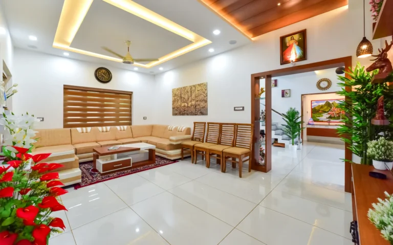 Living room interior with beige sofa and false ceiling – Varghese Residence Wadakkanchery