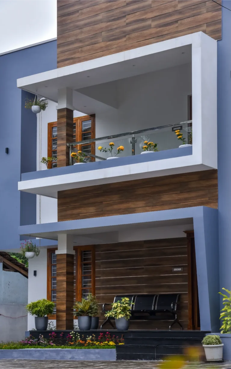 Balcony view with glass railing and flower planters – Varghese Residence Wadakkanchery