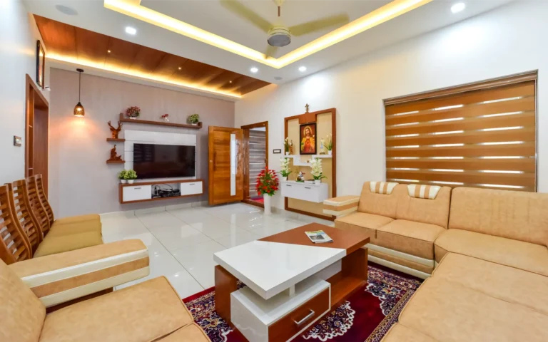 TV wall unit and sofa setup with warm lighting – Varghese Residence Wadakkanchery