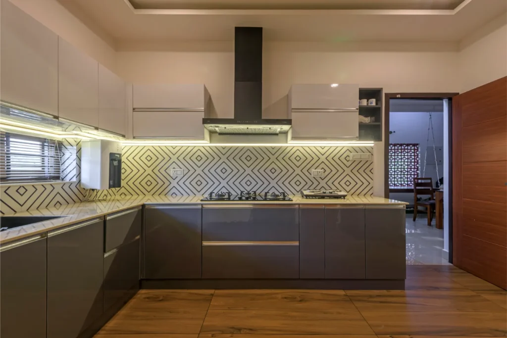 Modern kitchen with geometric backsplash – Vasudevam Residence Chalakudy