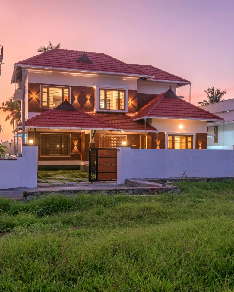 Two-storey red-tiled home with compound wall – Vasudevam Residence Chalakudy